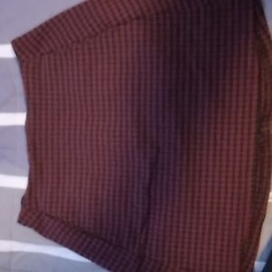 Small black and red plaid skirt has pockets